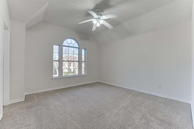 unfurnished room featuring ceiling fan, lofted ceiling, light carpet, and a textured ceiling