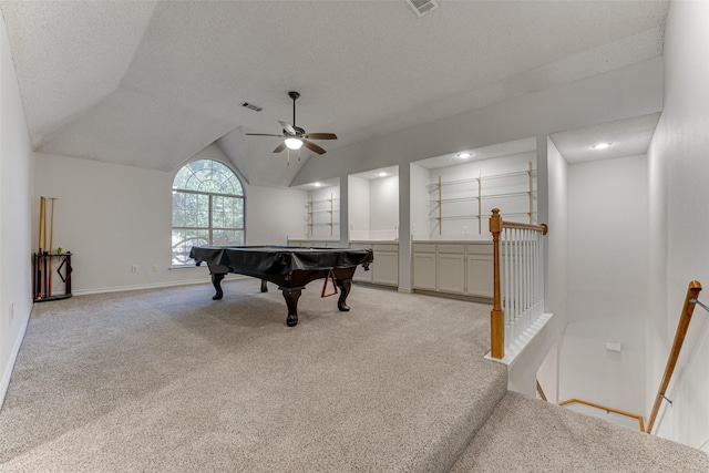 rec room featuring vaulted ceiling, billiards, light colored carpet, ceiling fan, and a textured ceiling