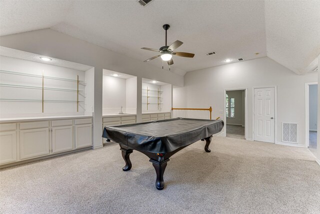 recreation room featuring sink, a textured ceiling, light carpet, pool table, and vaulted ceiling