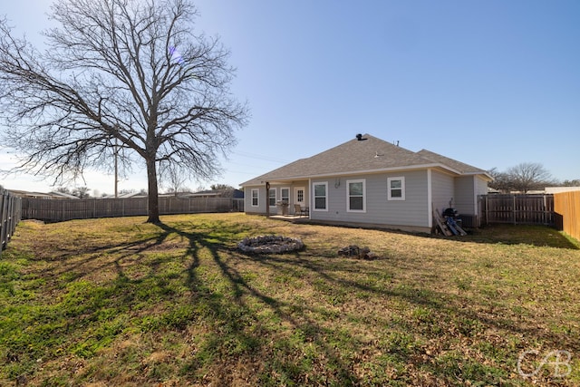 back of property featuring a yard