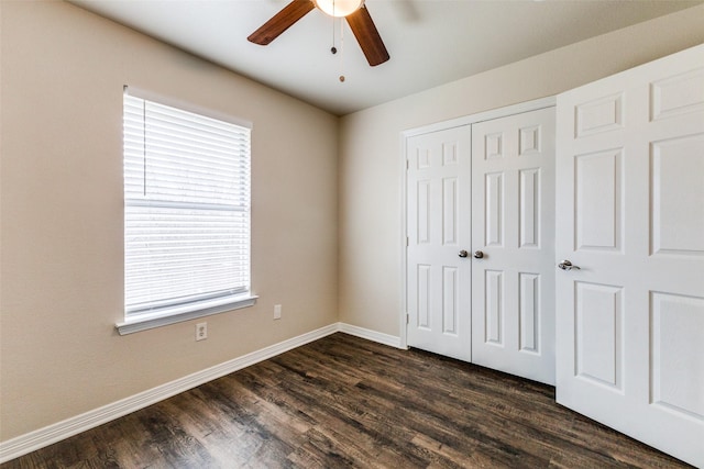 unfurnished bedroom featuring a closet, dark hardwood / wood-style floors, and ceiling fan