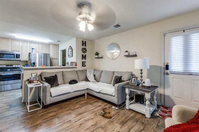 living room featuring hardwood / wood-style flooring and ceiling fan