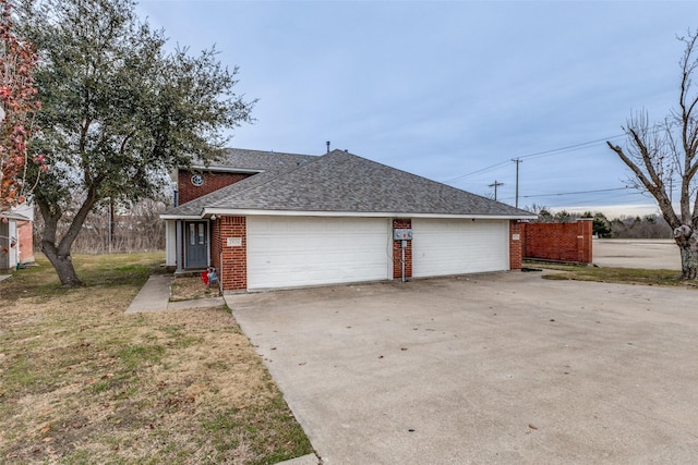 view of front of property with a garage and a front lawn