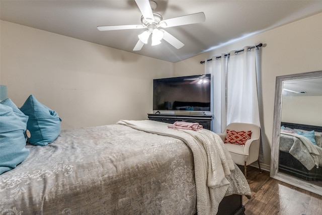 bedroom with ceiling fan and dark hardwood / wood-style floors