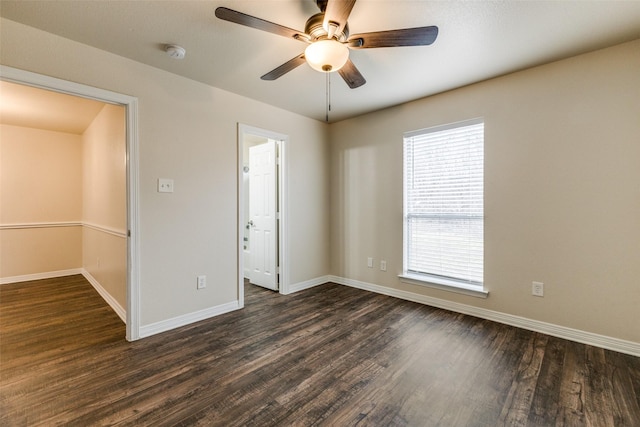 unfurnished room with ceiling fan and dark hardwood / wood-style flooring