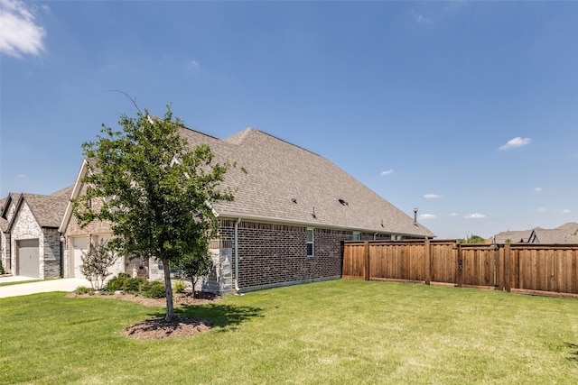 view of side of home with a garage and a yard