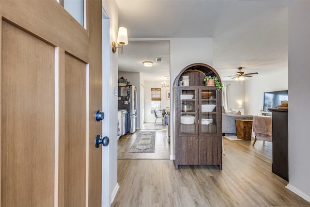 foyer entrance with hardwood / wood-style flooring and ceiling fan