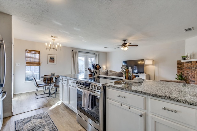 kitchen featuring white cabinetry, stainless steel electric stove, light hardwood / wood-style floors, and light stone counters