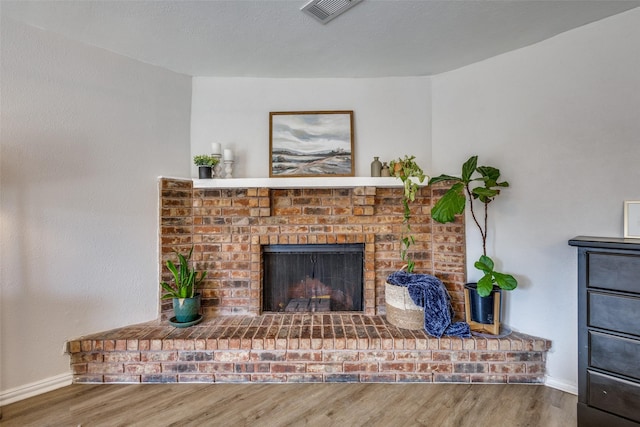 unfurnished living room with wood-type flooring and a fireplace