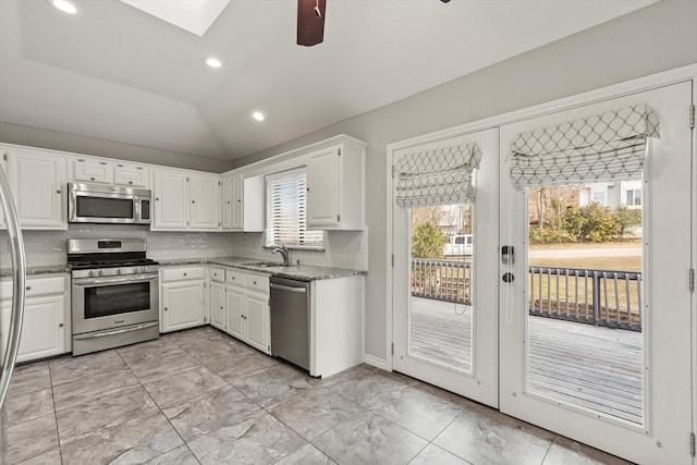 kitchen with white cabinetry, plenty of natural light, stainless steel appliances, and backsplash