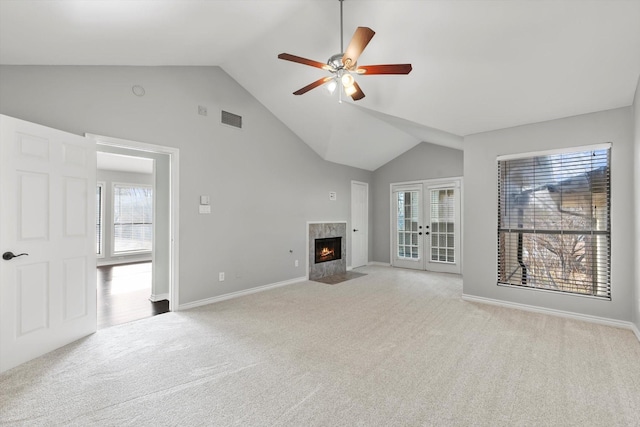 unfurnished living room with a fireplace with flush hearth, wood finished floors, visible vents, and baseboards