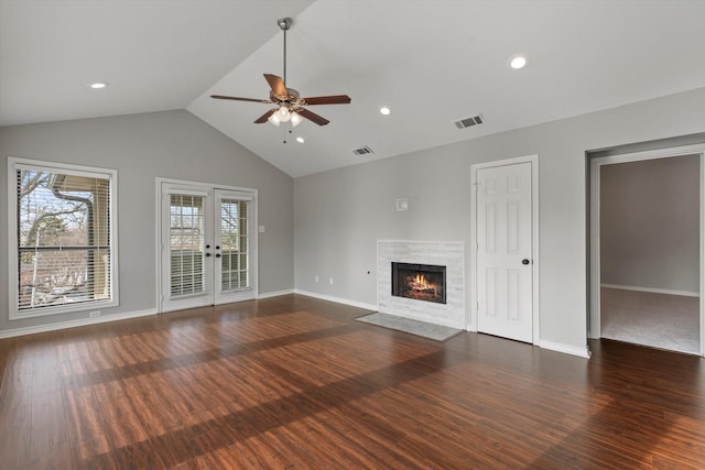 unfurnished living room with french doors, ceiling fan, dark hardwood / wood-style floors, and vaulted ceiling