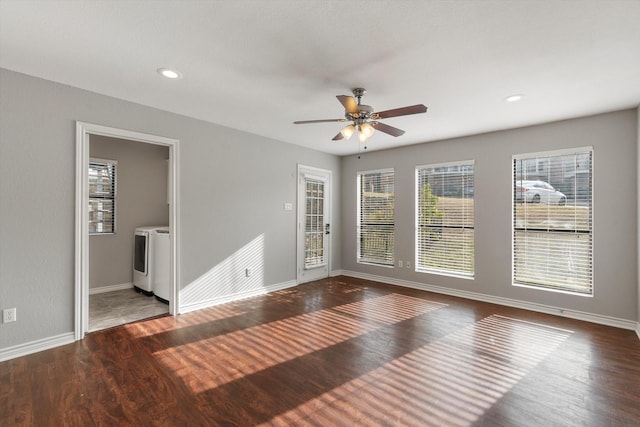 empty room with ceiling fan, dark hardwood / wood-style floors, and washer / dryer