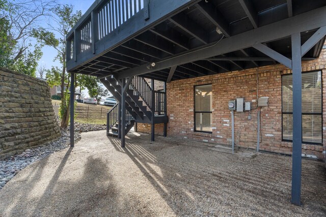 view of front facade featuring an attached garage, aphalt driveway, and brick siding