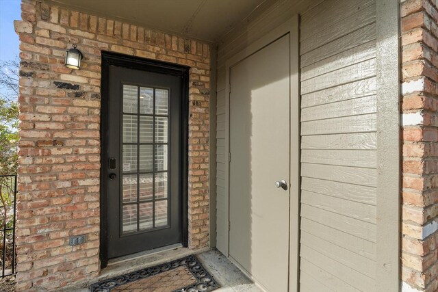 property entrance with brick siding