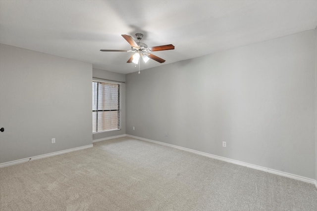 spare room featuring light carpet and ceiling fan