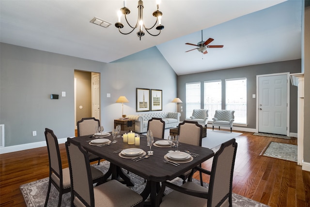 dining area featuring lofted ceiling, dark hardwood / wood-style floors, and ceiling fan with notable chandelier