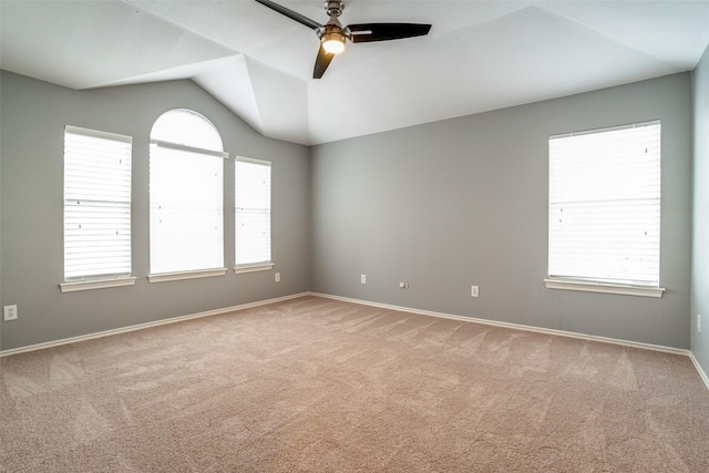 carpeted empty room with lofted ceiling and ceiling fan