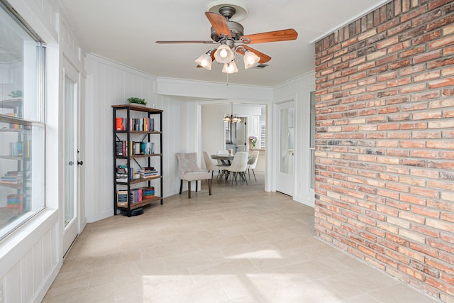 corridor with crown molding, brick wall, and an inviting chandelier