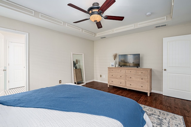 bedroom with dark hardwood / wood-style floors and ceiling fan