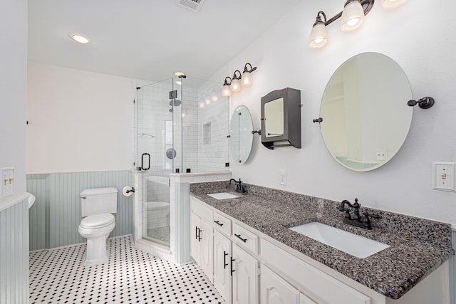 bathroom featuring an enclosed shower, vanity, and toilet