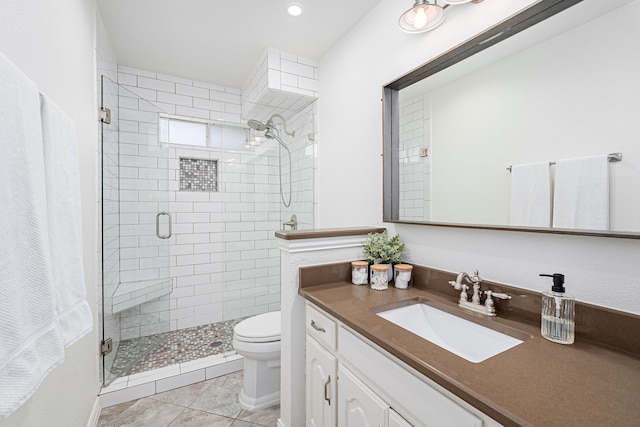 bathroom featuring tile patterned floors, vanity, toilet, and an enclosed shower