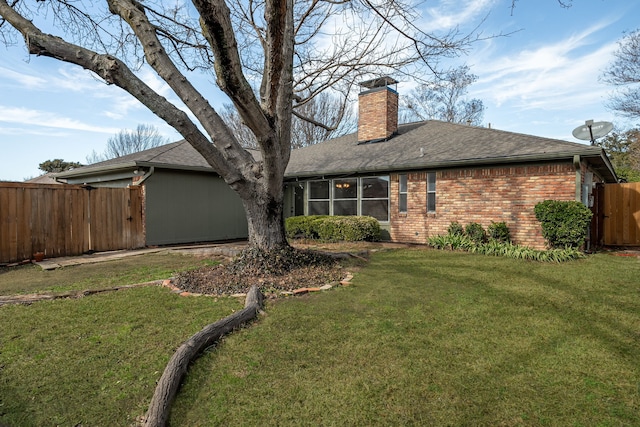 rear view of property featuring a yard