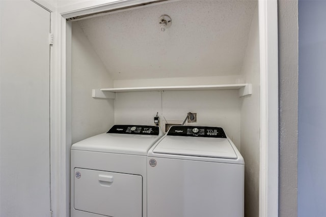 clothes washing area with washing machine and dryer