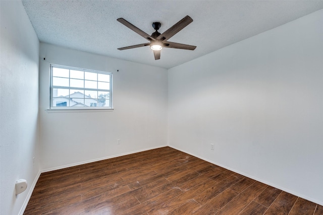 empty room featuring ceiling fan, a textured ceiling, and dark hardwood / wood-style flooring