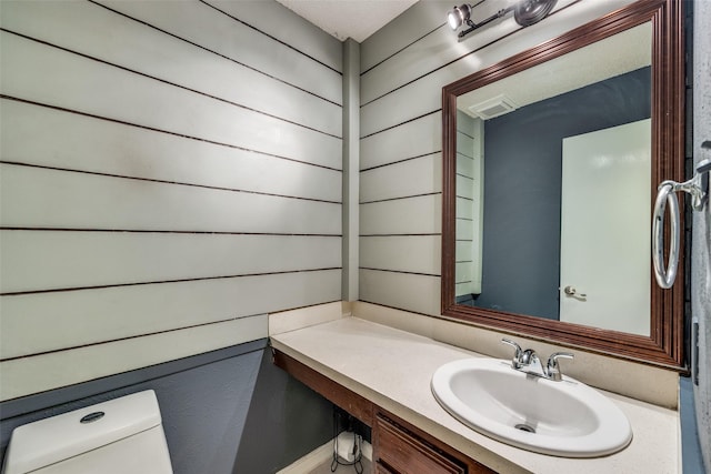 bathroom featuring vanity and toilet