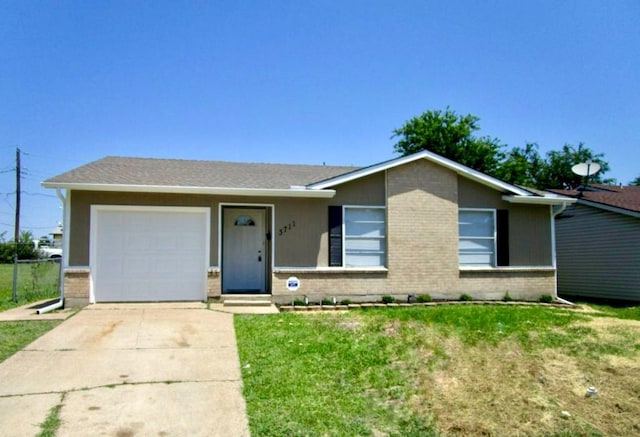 single story home featuring a garage and a front lawn