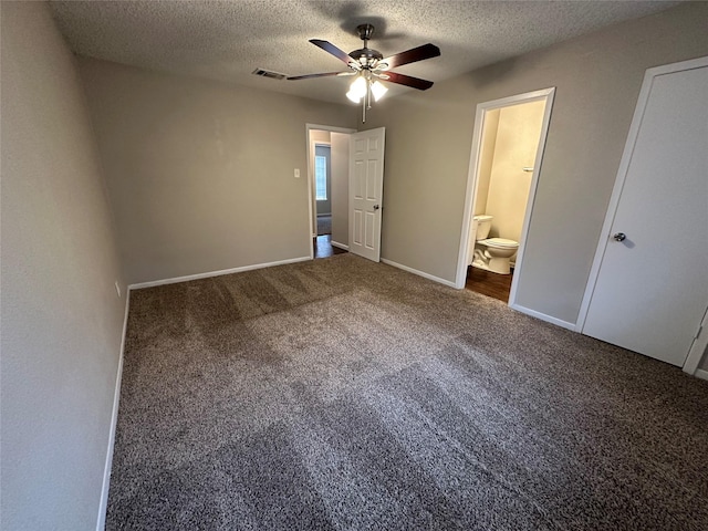 unfurnished bedroom with ensuite bathroom, carpet floors, ceiling fan, and a textured ceiling