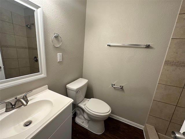 bathroom featuring hardwood / wood-style flooring, vanity, and toilet