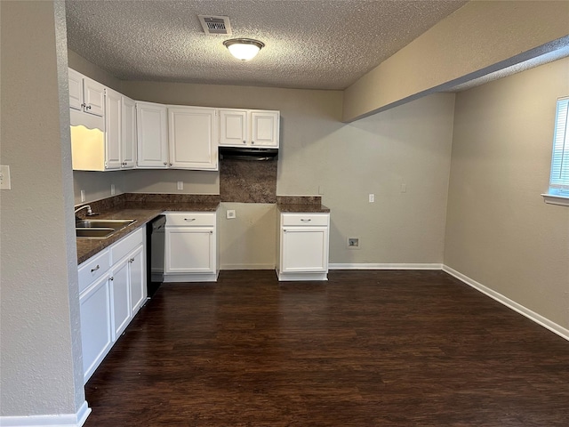 kitchen featuring black dishwasher, sink, white cabinets, dark hardwood / wood-style flooring, and a textured ceiling