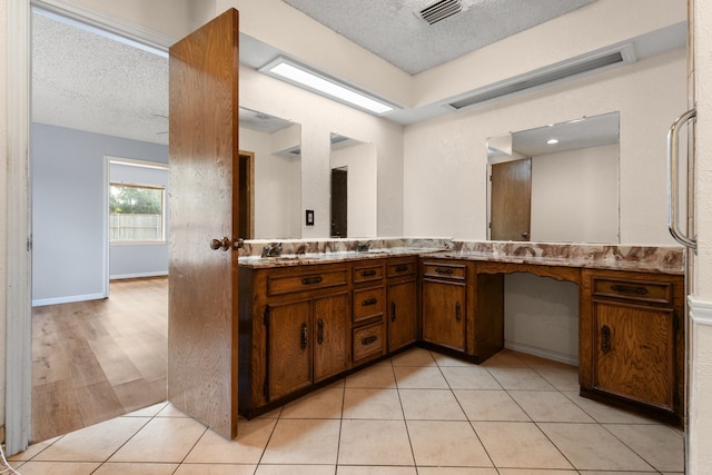 bathroom with vanity, tile patterned floors, and a textured ceiling