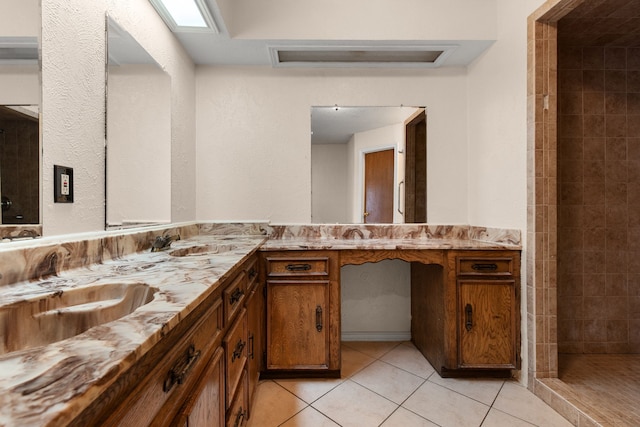 bathroom featuring vanity, tiled shower, and tile patterned floors