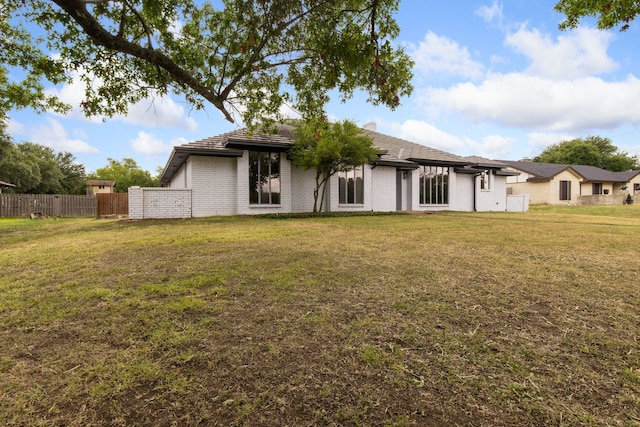 back of house featuring a lawn