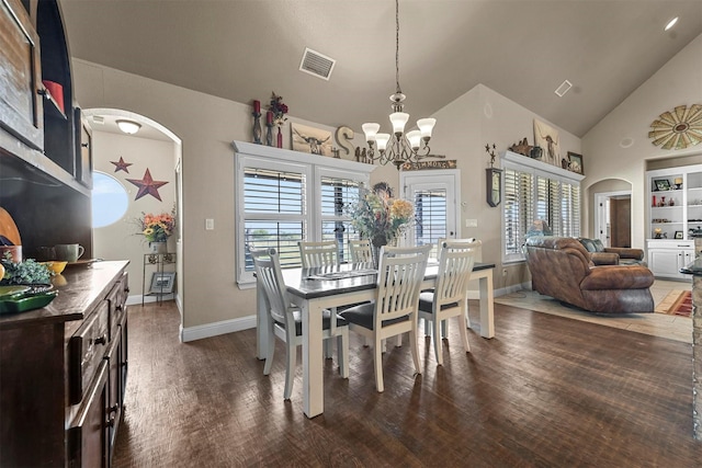 dining room with dark hardwood / wood-style flooring, high vaulted ceiling, and a chandelier