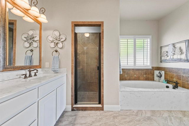 bathroom with vanity and shower with separate bathtub