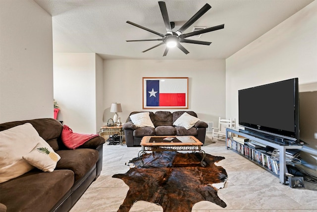 living room with a textured ceiling and ceiling fan