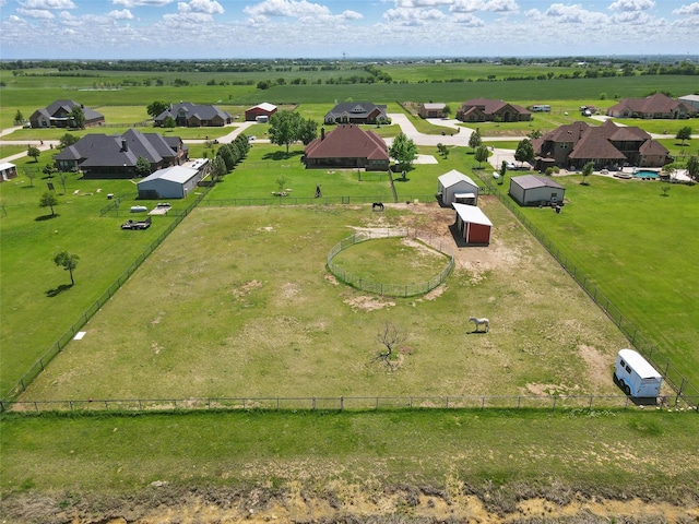 view of yard with fence and a rural view