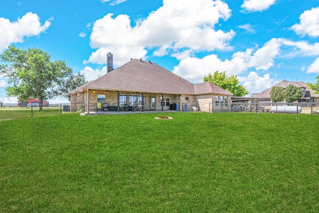 back of house featuring a yard and a patio area