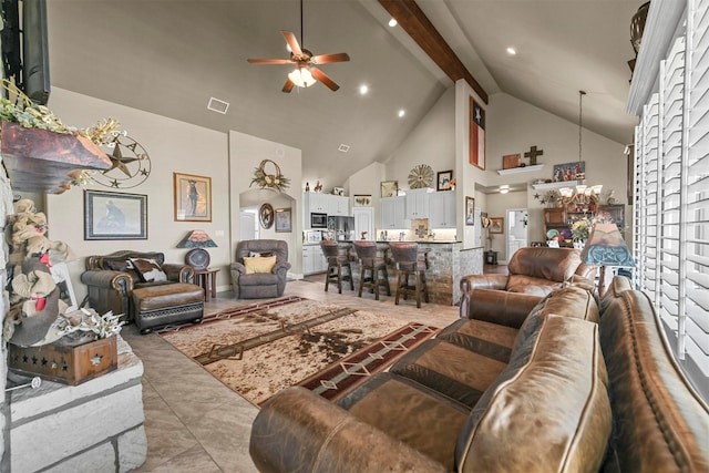 tiled living room featuring ceiling fan with notable chandelier, beam ceiling, and high vaulted ceiling