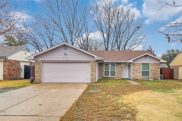 single story home with a garage and a front yard