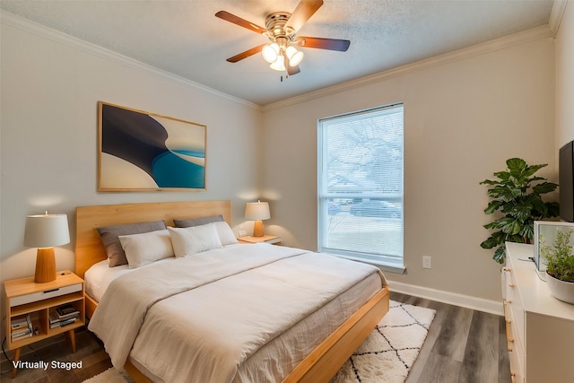 bedroom with dark hardwood / wood-style flooring, crown molding, and ceiling fan