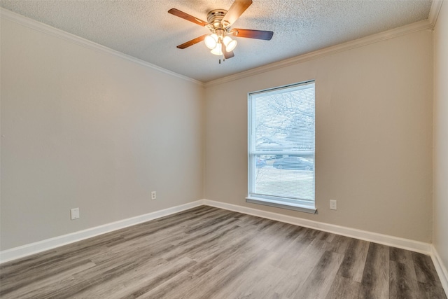 spare room featuring crown molding, ceiling fan, wood-type flooring, and a textured ceiling