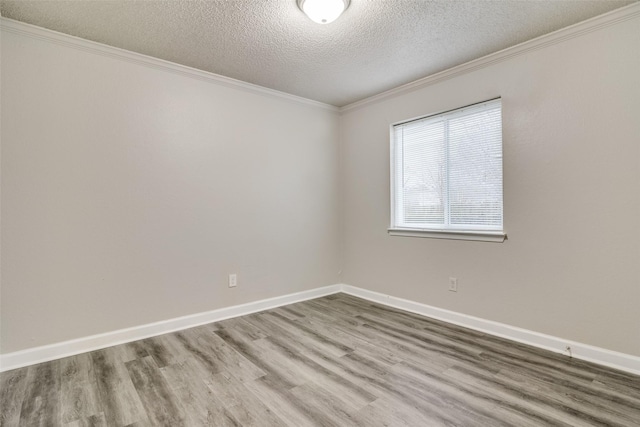 unfurnished room featuring hardwood / wood-style flooring, ornamental molding, and a textured ceiling