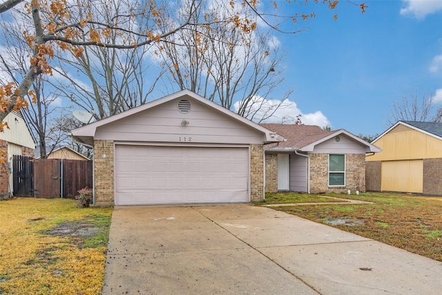 single story home with a garage and a front lawn