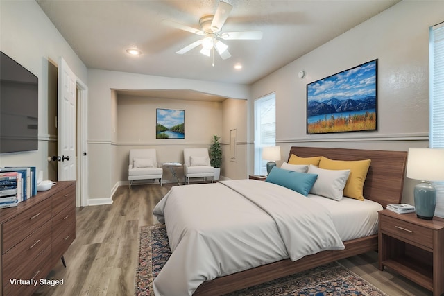 bedroom featuring hardwood / wood-style flooring and ceiling fan