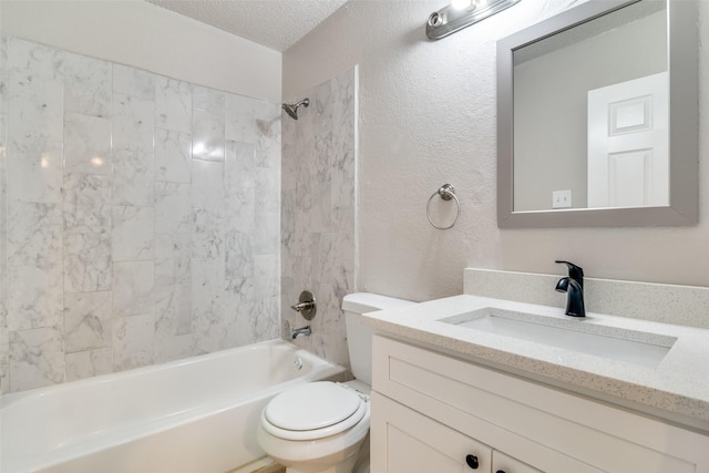 full bathroom featuring vanity, tiled shower / bath combo, toilet, and a textured ceiling